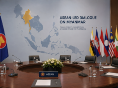 ASEAN Myanmar Talks Open New Dialogue ASEAN Myanmar talks illustrated with Philippine and ASEAN flags beside a diplomatic conference table.