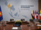 ASEAN Myanmar Talks Open New Dialogue ASEAN Myanmar talks illustrated with Philippine and ASEAN flags beside a diplomatic conference table.